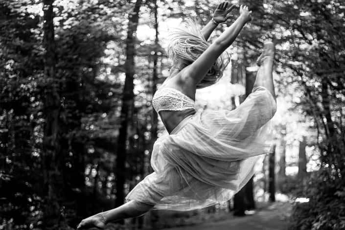 A ballerina flexes an artistic jump.