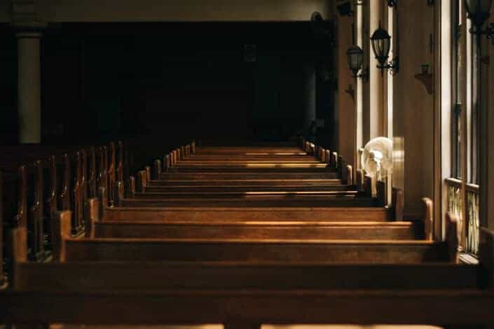 Array of long benches inside the church.