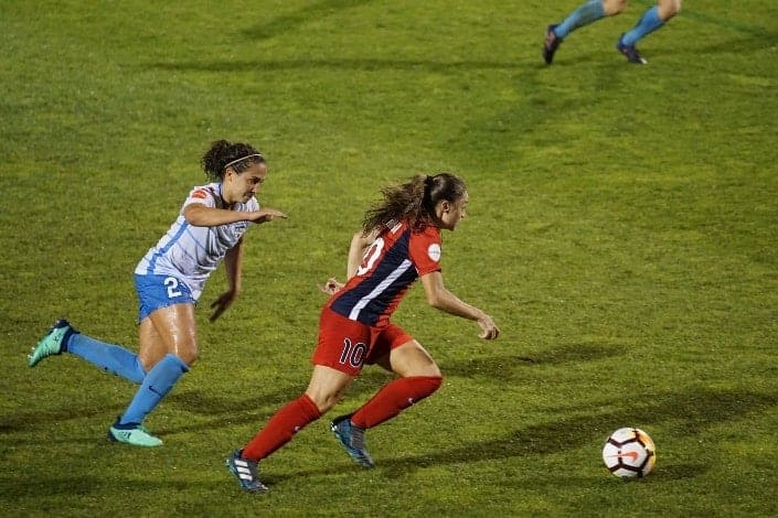 two women playing soccer