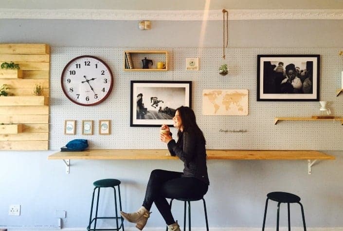 Girl sitting down while drinking coffee
