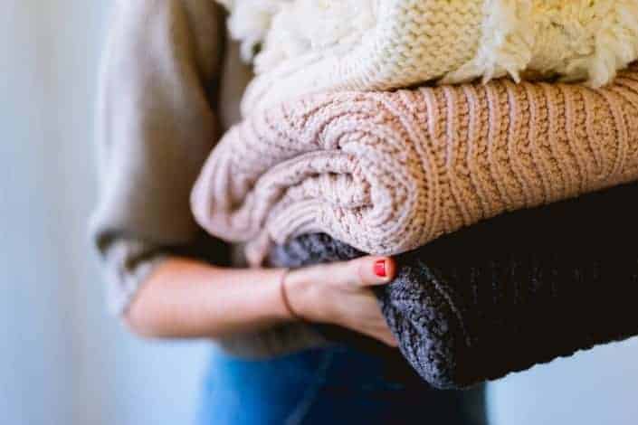woman carrying a knit sweaters