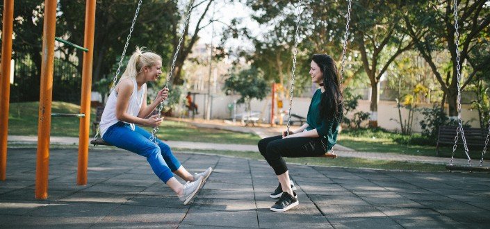 two women laughing at the playground