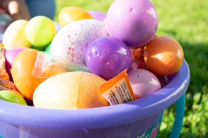 a bucket full of colored eggs