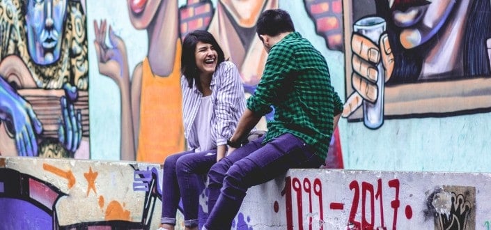 couple sitting while laughing