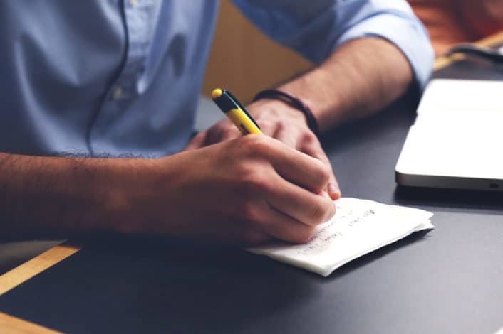 a man writing notes