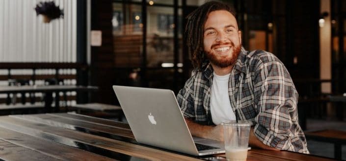 man with a laptop smiling