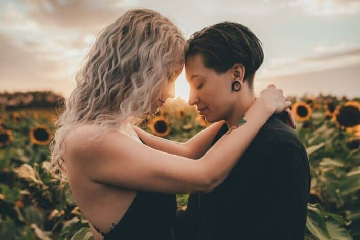 Couple in the middle of sunflower garden